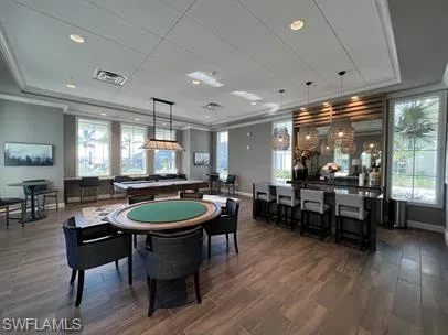a living room with patio furniture and a chandelier