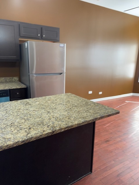 1500 East 73rd Street, Unit 3 Chicago, IL 60619 - Photo 5 of 13 a bathroom with a granite countertop sink and a refrigerator
