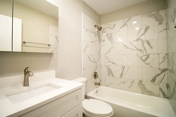 a bathroom with a sink a toilet and a bathtub