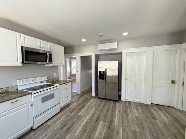 a kitchen with stainless steel appliances granite countertop a stove a sink and a refrigerator