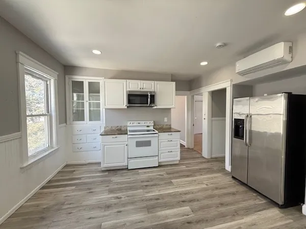 a kitchen with stainless steel appliances a refrigerator sink and microwave