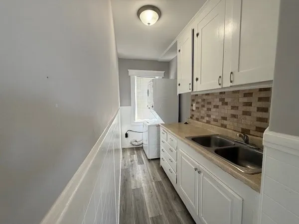a kitchen with sink and cabinets