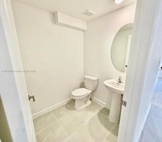 a bathroom with a toilet and a mirror