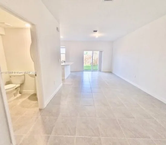 a view of hallway with a window and a sink