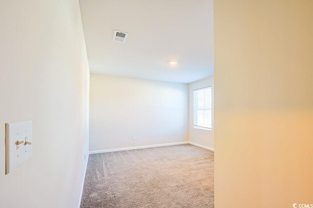 1560 Swing Bridge Way Myrtle Beach, SC 29588 - Photo 18 of 35 Empty room with light colored carpet and baseboards