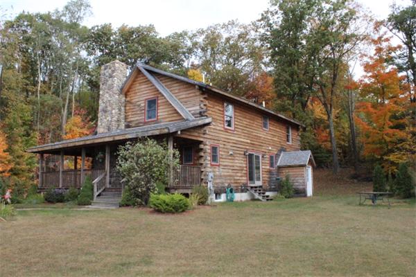 386 Piper Road Ashby, MA 01431 - Photo 22 of 24 front view of a house with a small yard