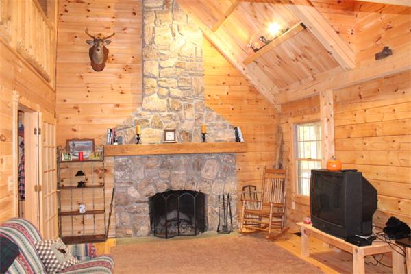 386 Piper Road Ashby, MA 01431 - Photo 5 of 24 a living room with furniture a fireplace and a flat screen tv