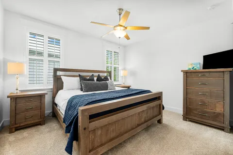 a bedroom with a bed and a chandelier