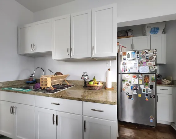 a kitchen with refrigerator and cabinets