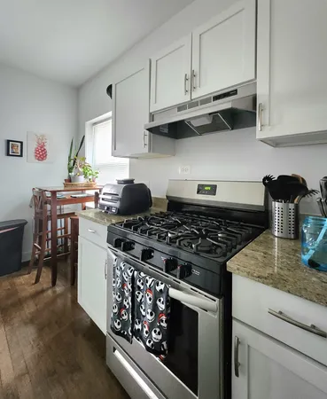 a stove top oven sitting inside of a kitchen