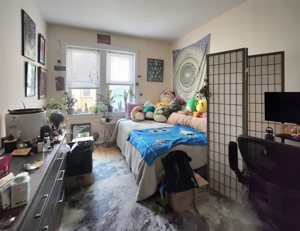 a living room with furniture a rug and a flat screen tv