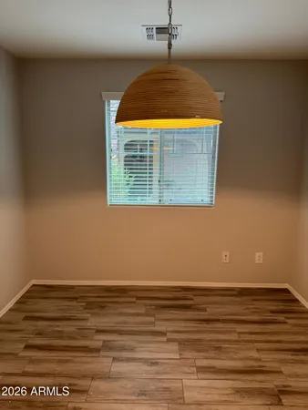 a view of a room with wooden floor and a window