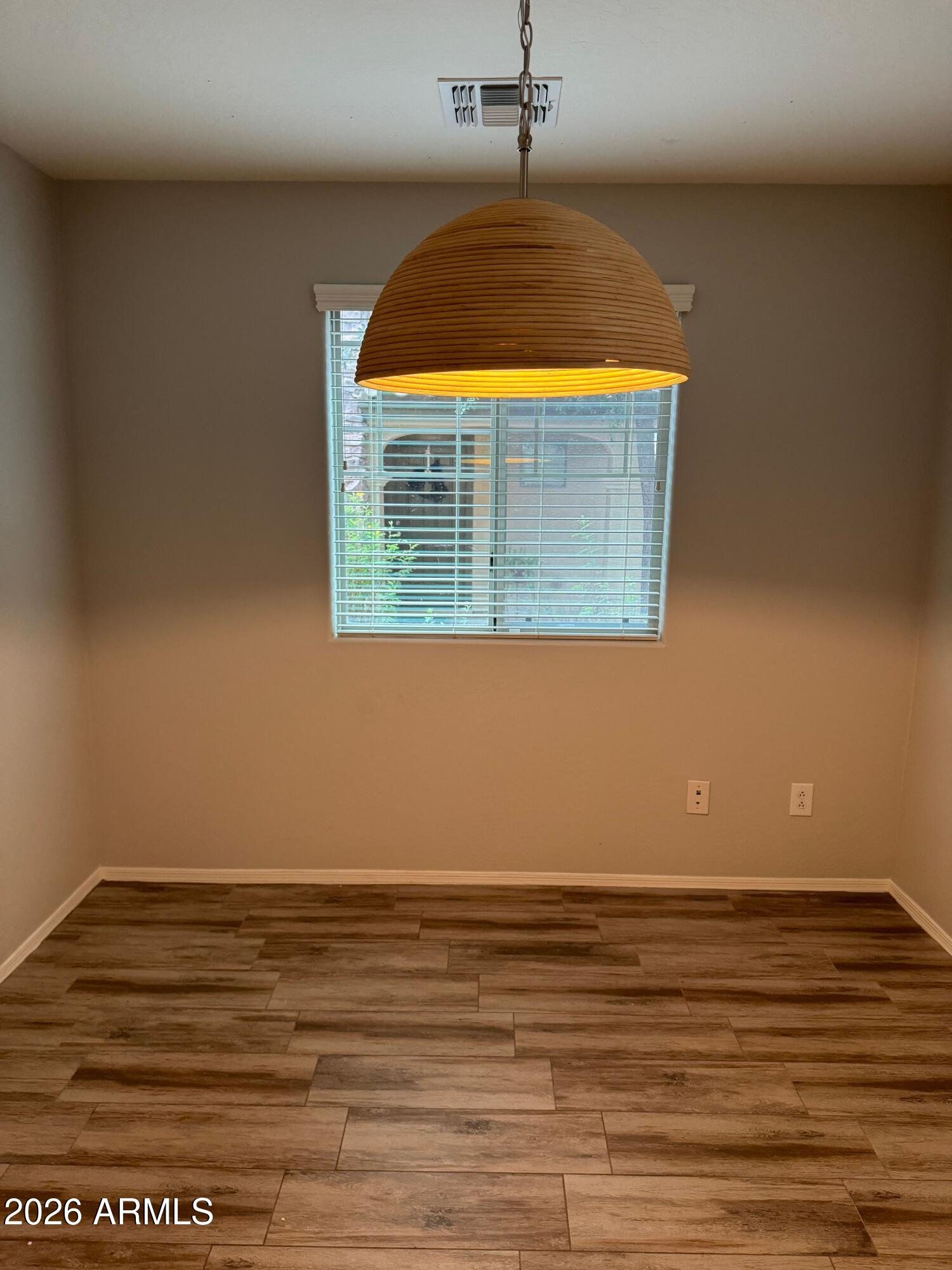 2491 East Boston Street Gilbert, AZ 85295 - Photo 2 of 22 a view of a room with wooden floor and a window