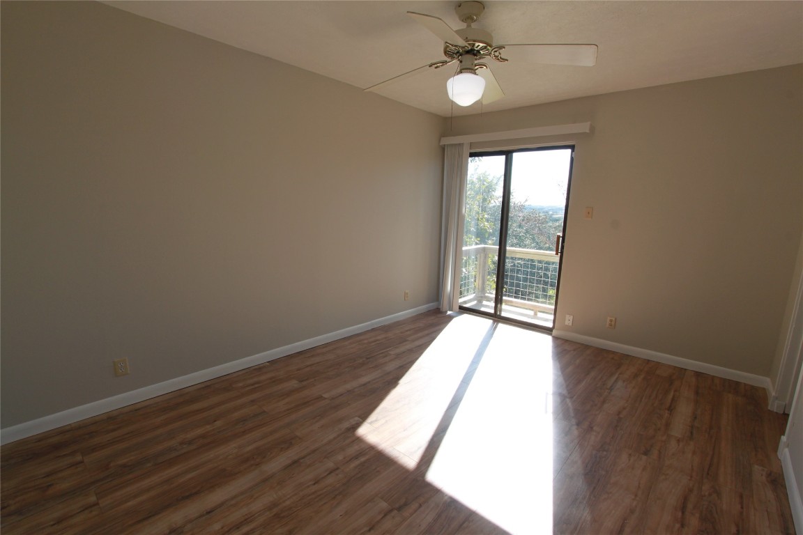 3904 Hudson Bend Road, Unit D Austin, TX 78734 - Photo 17 of 25 Unfurnished room with dark wood-style floors and a ceiling fan