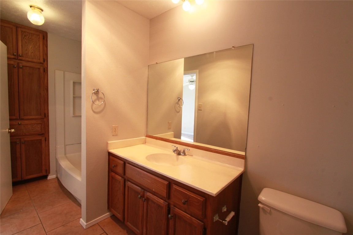 3904 Hudson Bend Road, Unit D Austin, TX 78734 - Photo 20 of 25 Full bath featuring vanity, light tile patterned floors, and shower / washtub combination