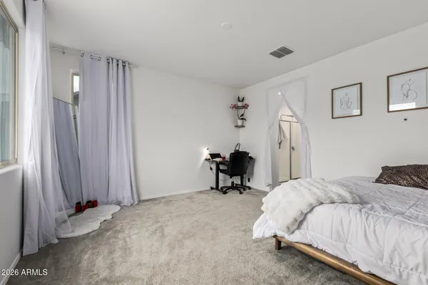 a bedroom with a bed and a chair