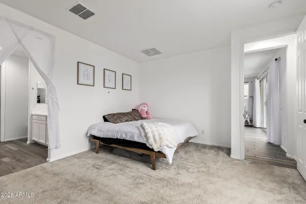 a spacious bedroom with a bed and a view of bathroom