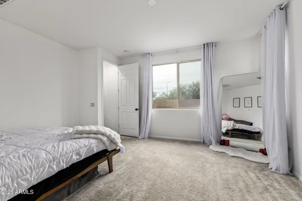 a bedroom with a bed and a window