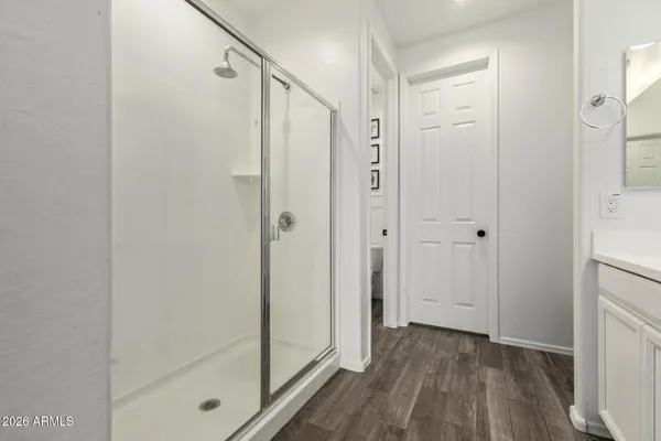 a bathroom with a shower and a glass door