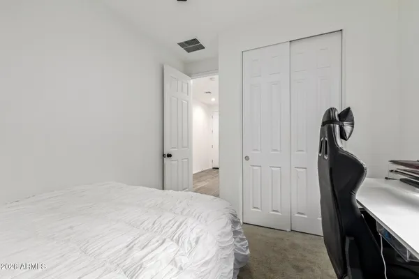 a bedroom with a sink and a mirror