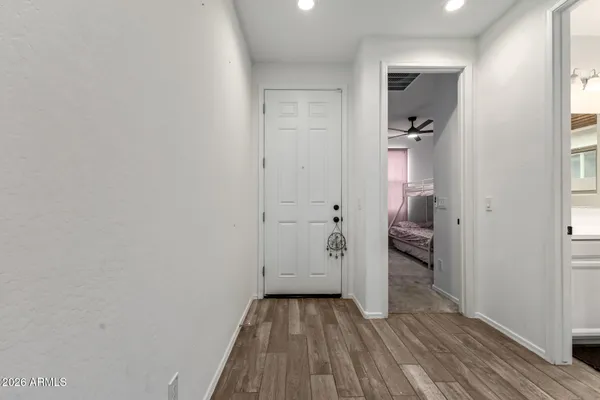 a view of a room with wooden floor