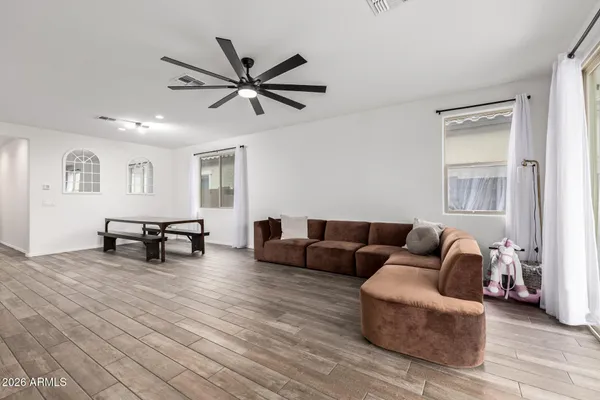 a living room with furniture and a wooden floor