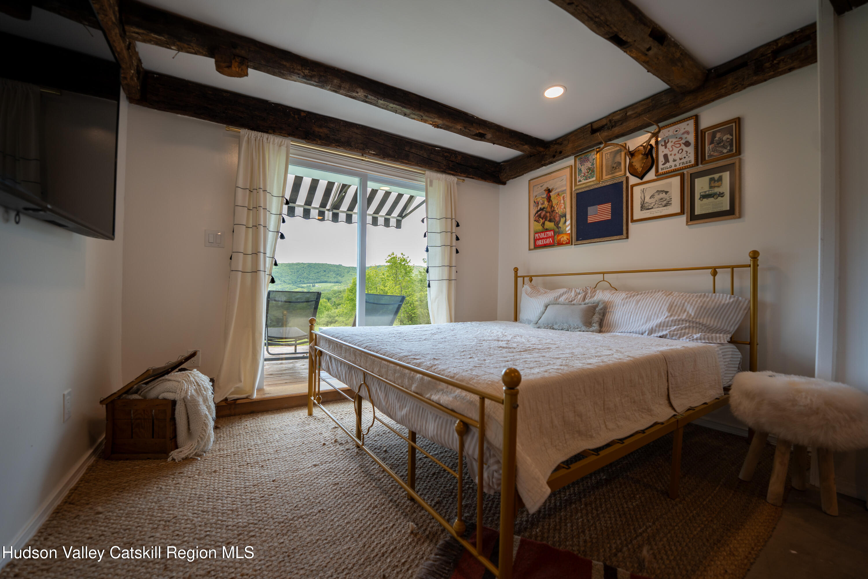 822 Burton Hall Road Margaretville, NY 12455 - Photo 21 of 32 a bedroom with a bed and a large window