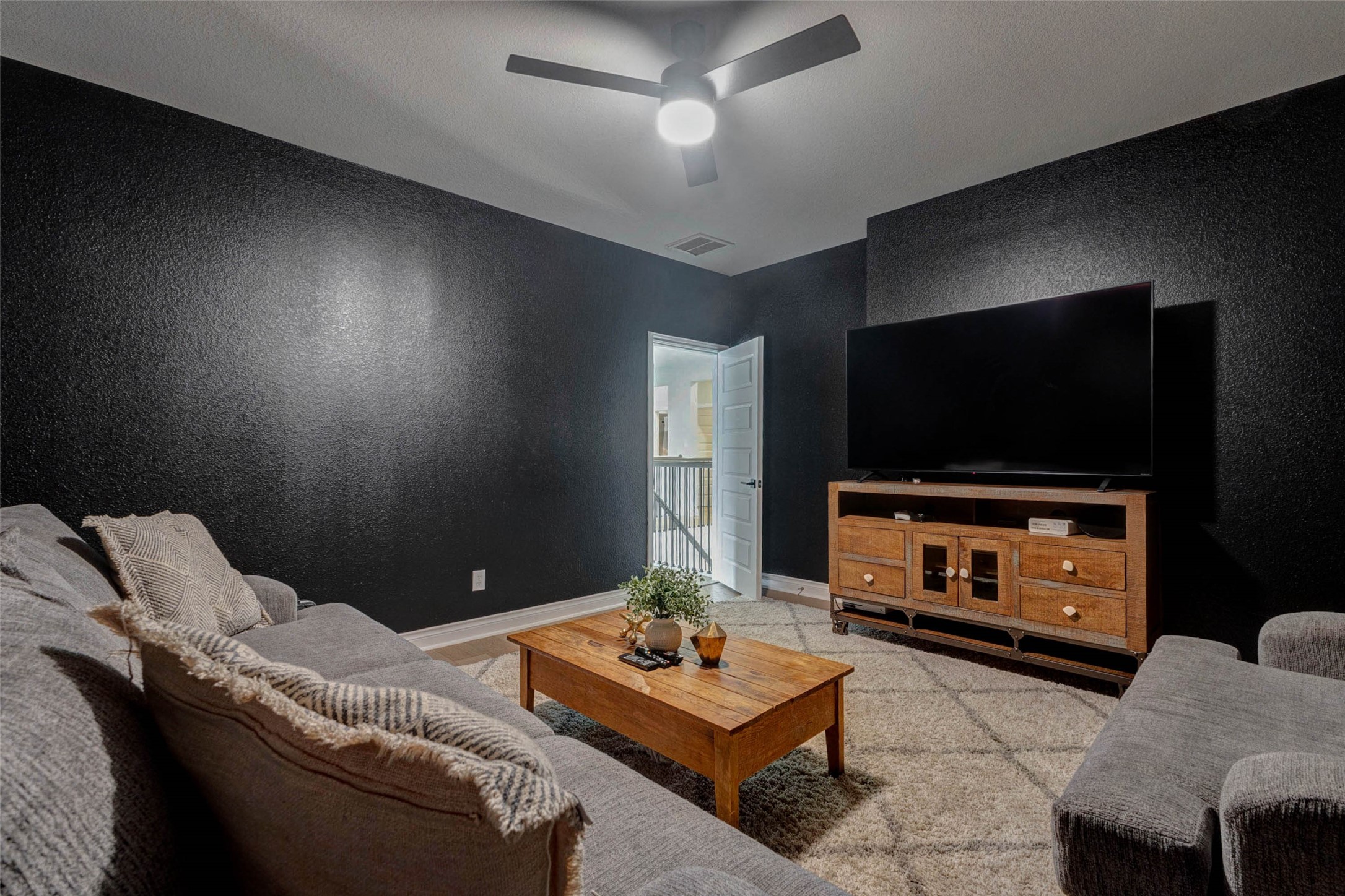 4303 Tupelo Leaf Court Manvel, TX 77578 - Photo 40 of 50 a living room with furniture and a flat screen tv