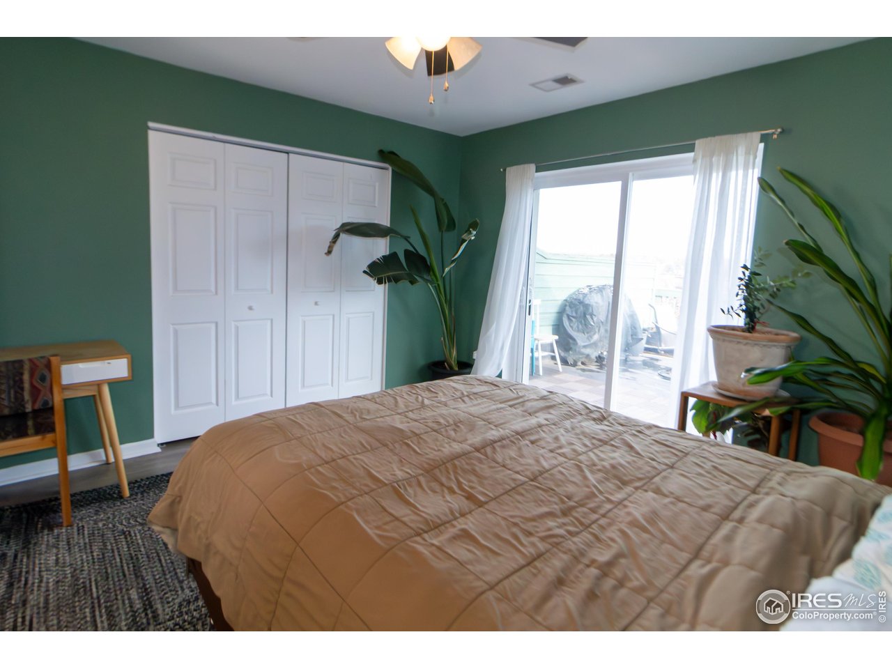 4651 Portside Way Boulder, CO 80301 - Photo 12 of 19 a bedroom with a bed a chair and a large window
