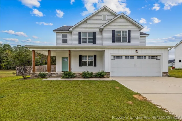 a front view of a house with a yard and garage