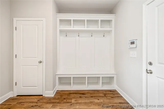a view of empty room with wooden floor and cabinet