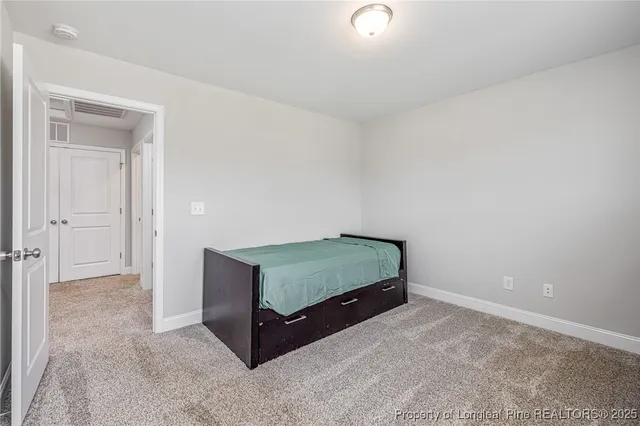 an empty room with a dresser