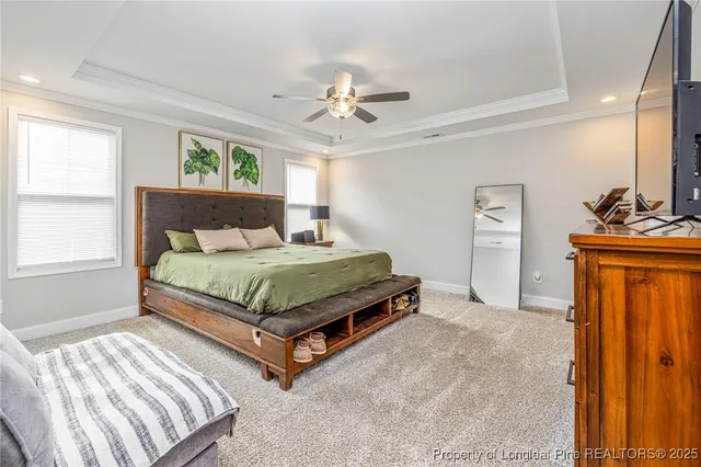 a spacious bedroom with a bed a couch and a window