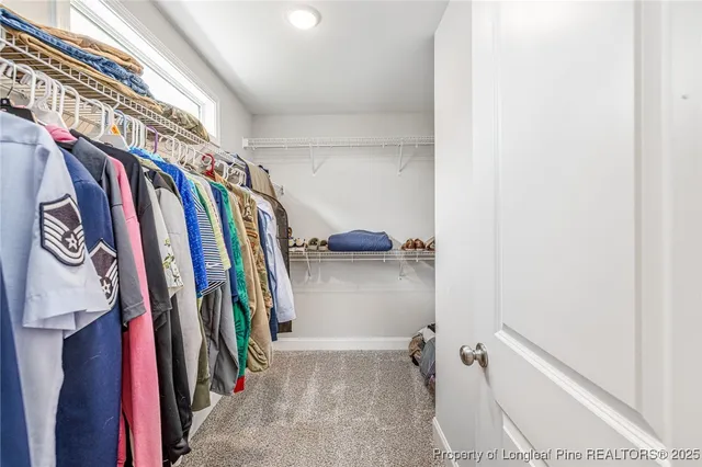 a spacious bathroom with a double vanity sink a mirror and shower