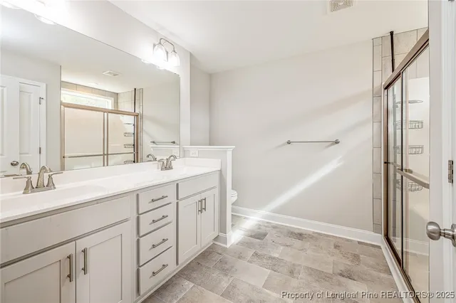 a bathroom with a shower and a glass door