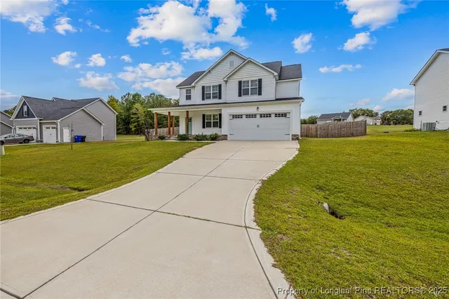 a front view of a house with a big yard