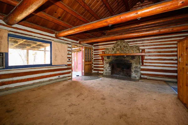 a view of an empty room with a fireplace