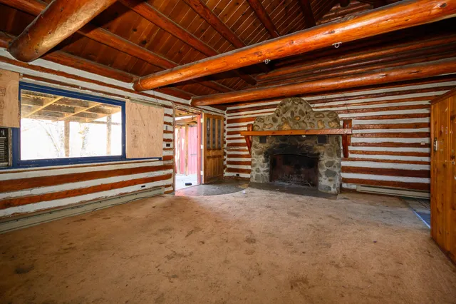 a view of an empty room with a fireplace