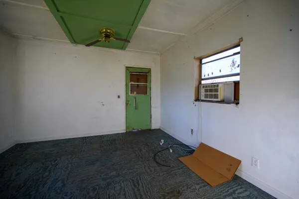 a view of a room with wooden floor and windows