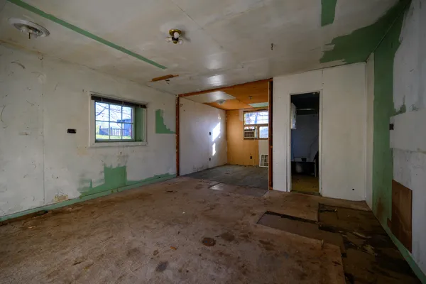 en empty room with windows and entrance