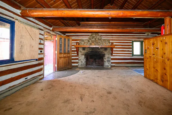a view of empty room with wooden floor and windows