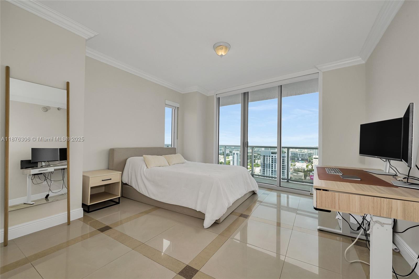 185 Southwest 7th Street, Unit 4201 Miami, FL 33130 - Photo 15 of 29 a bedroom with a bed and large window