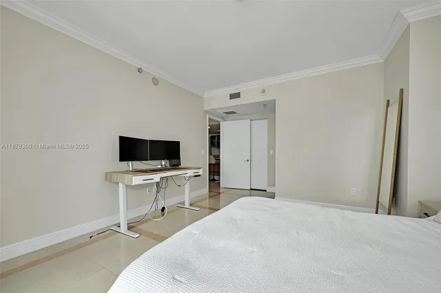 a hotel room with a bed and a television in it