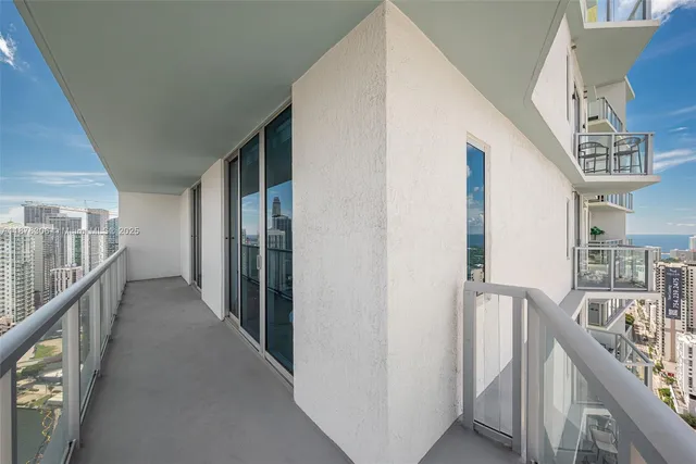 a view of a hallway with wooden stairs and stairs