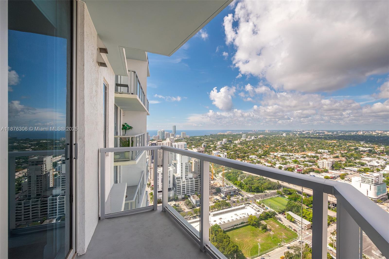 185 Southwest 7th Street, Unit 4201 Miami, FL 33130 - Photo 29 of 29 a view of a balcony with wooden floor and fence