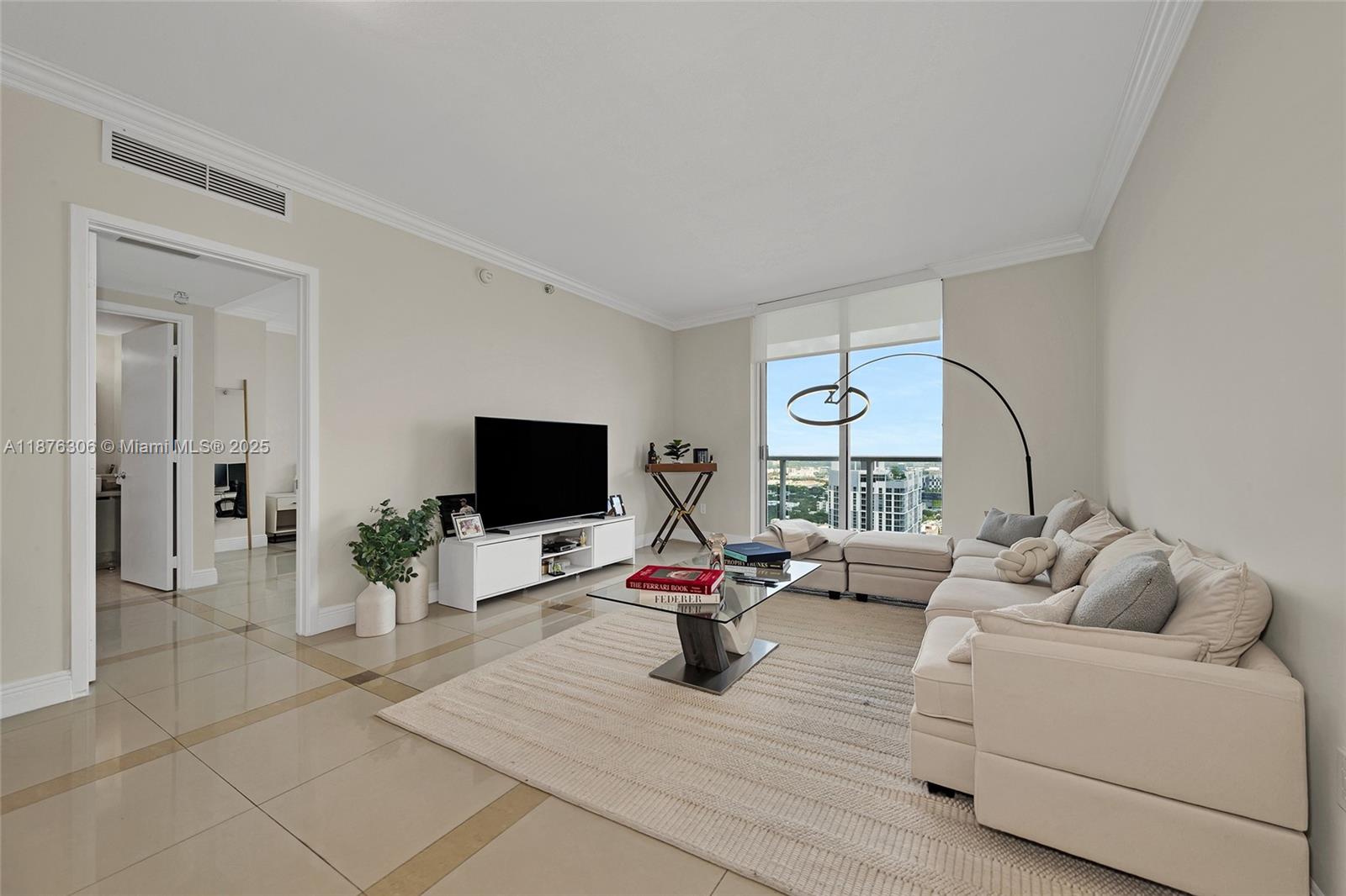 185 Southwest 7th Street, Unit 4201 Miami, FL 33130 - Photo 5 of 29 a living room with furniture and a flat screen tv