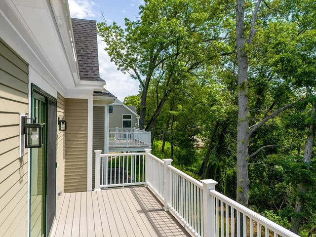 a view of a wooden deck and a forest