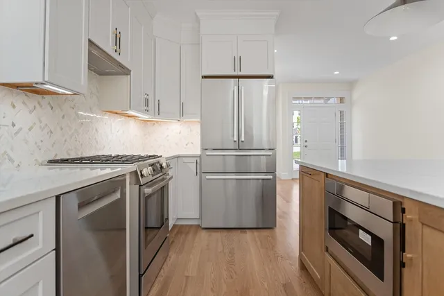 a kitchen with a stove a refrigerator and a sink