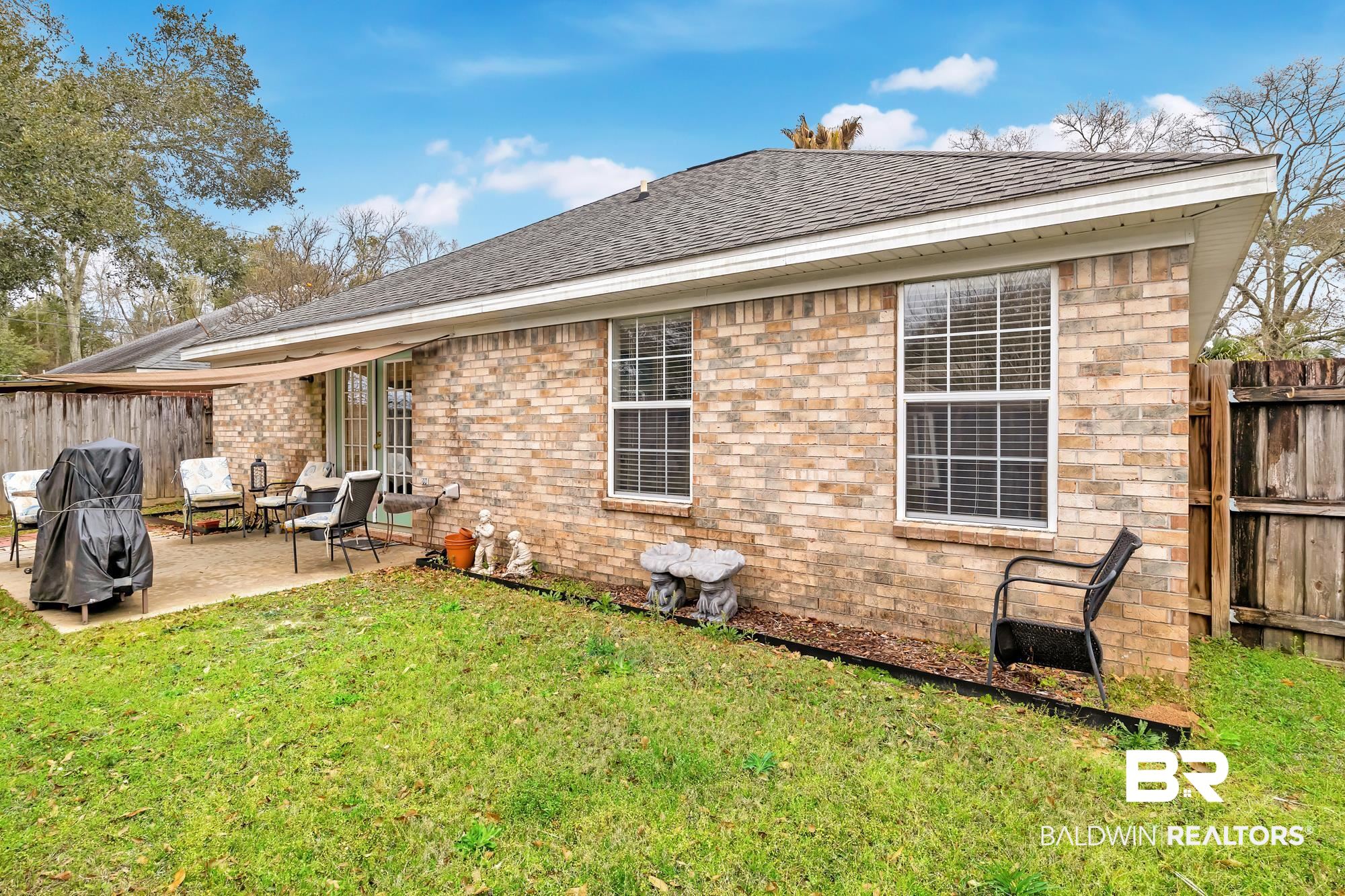 105 Cluster Oaks Court Foley, AL 36535 - Photo 24 of 26 Rear view of property with a patio and roof with shingles