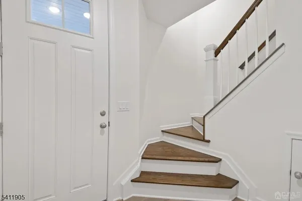 a view of staircase with white walls and a window